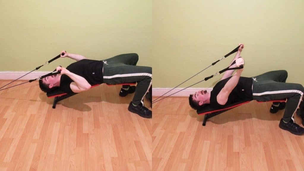 A man performing a resistance band decline skull crusher