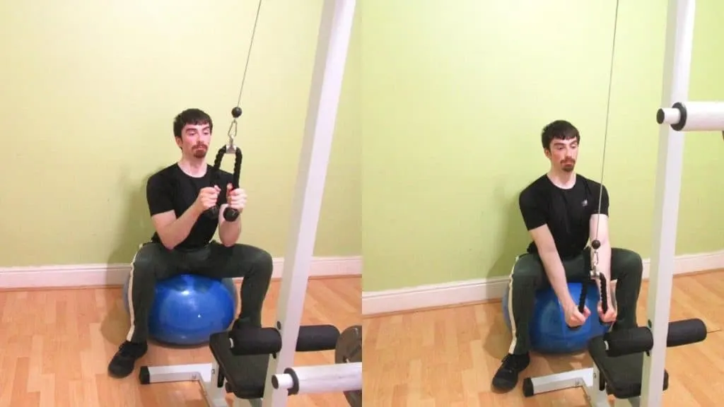 A man performing a rope pushdown on a stability ball