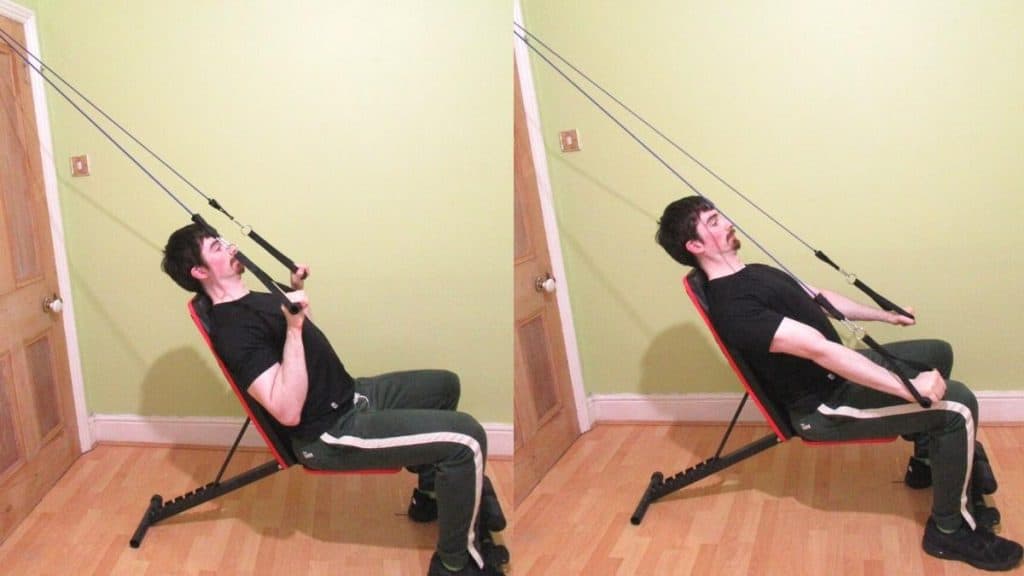 A man doing a seated resistance band tricep pressdown