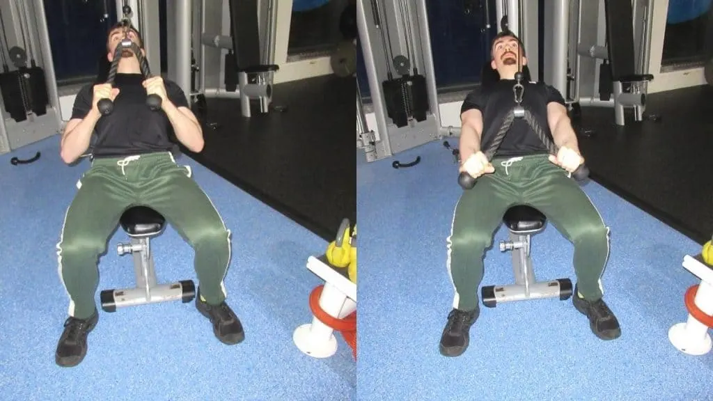 A man doing a sitting tricep pushdown with a rope