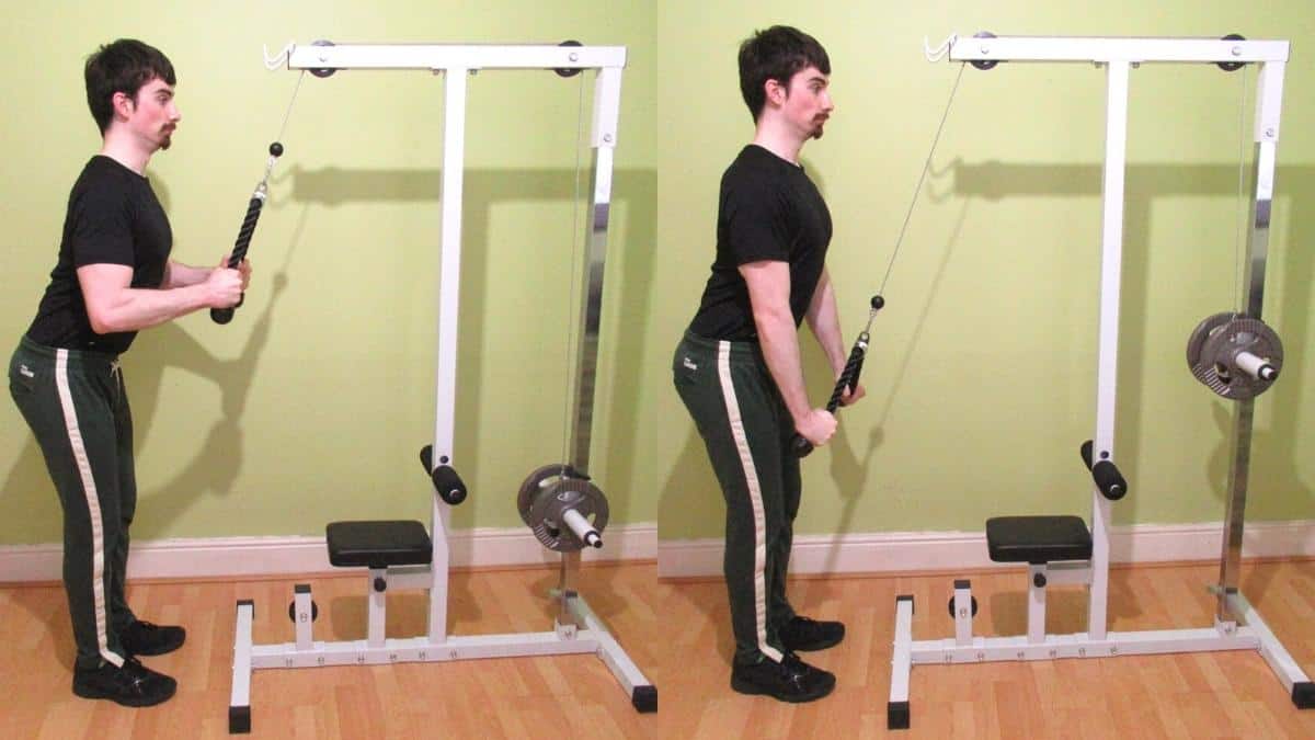 A man doing a standing cable tricep pushdown exercise with a rope attachment during his workout