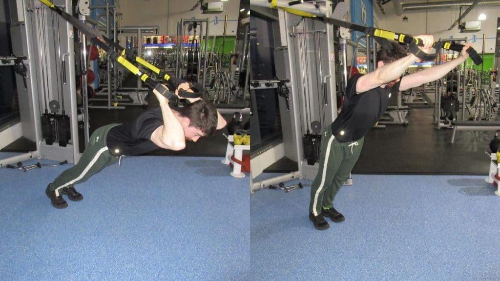 A man doing a tricep extension with a TRX