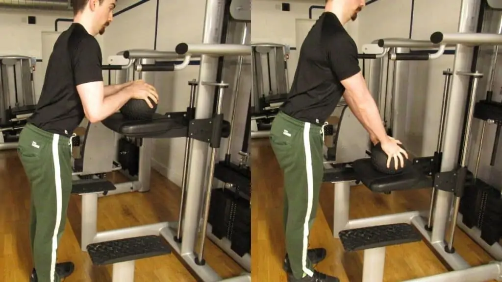 A man performing a tricep pushdown on the assisted pullup machine