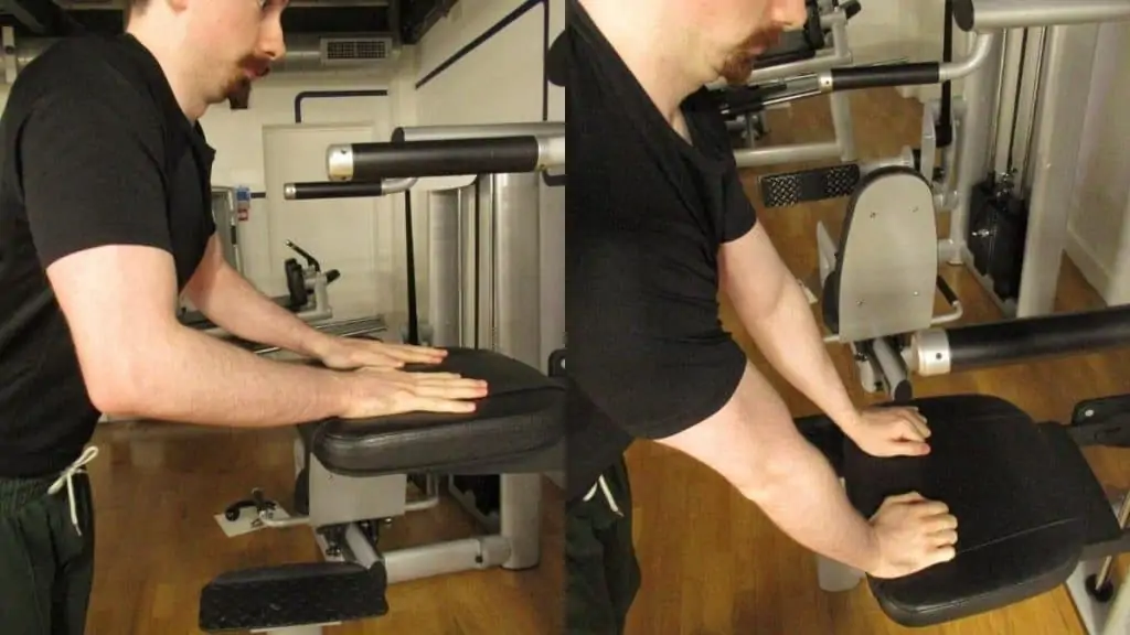 A man performing a tricep pushdown on an assisted pull up station