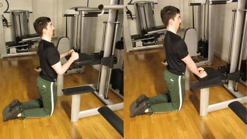 A man doing a tricep pushdown using the assisted pull up machine