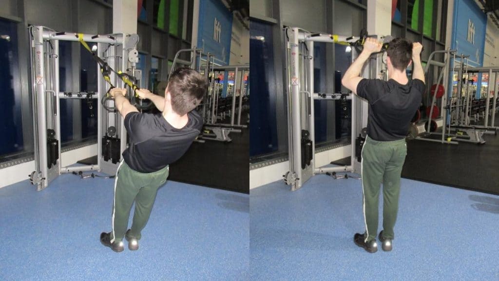 A man doing a TRX reverse grip bicep curl