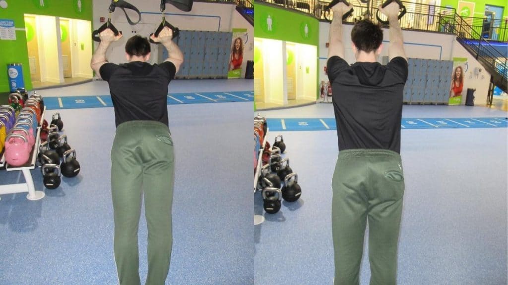 A man at the gym performing a TRX skullcrusher for his triceps