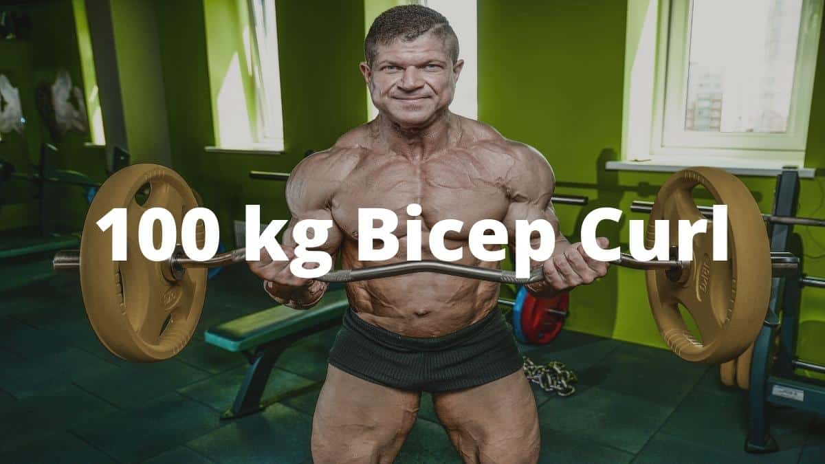A bodybuilder performing a 100 kg bicep curl with a barbell