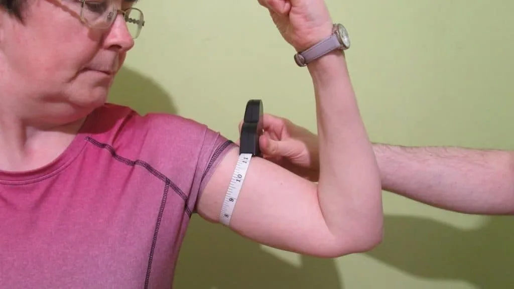 A female flexing her 11 inch arms