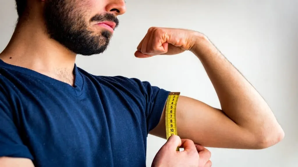 A man showing his small 11 inch arms