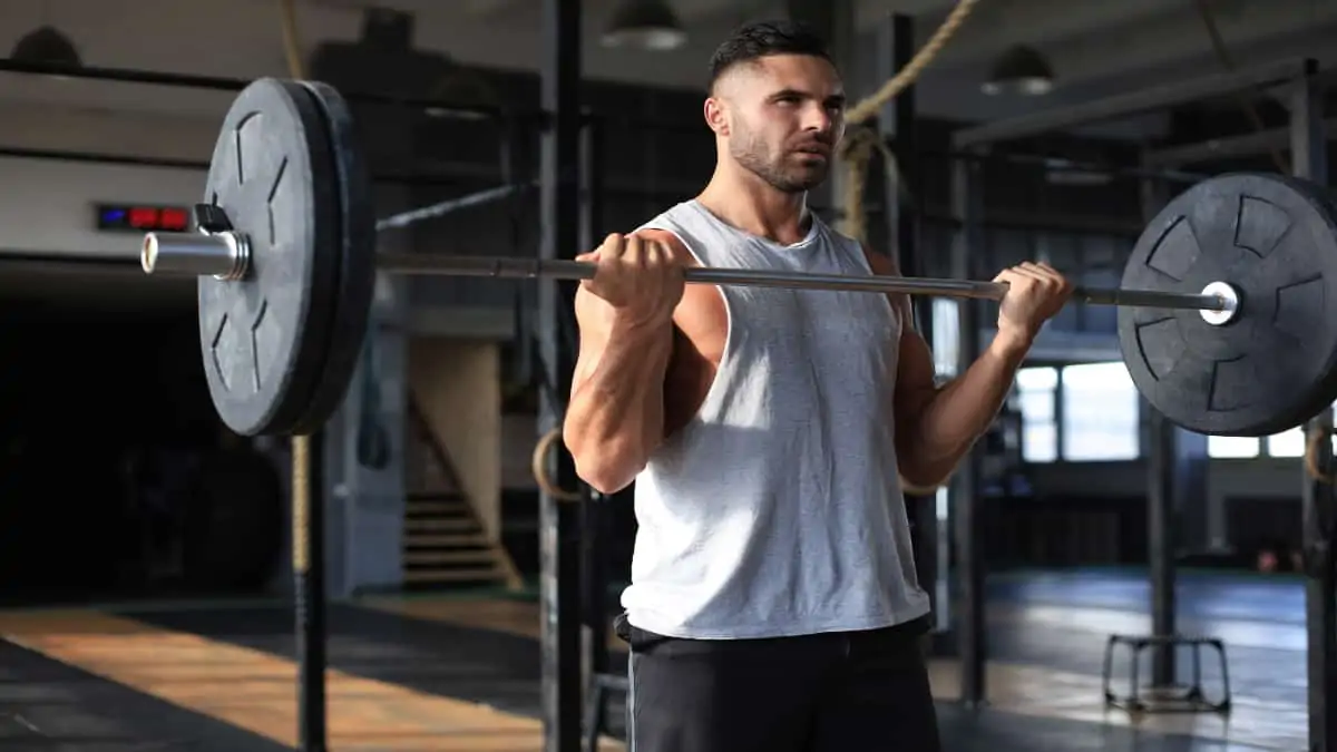 A man doing a 135 pound curl for his biceps