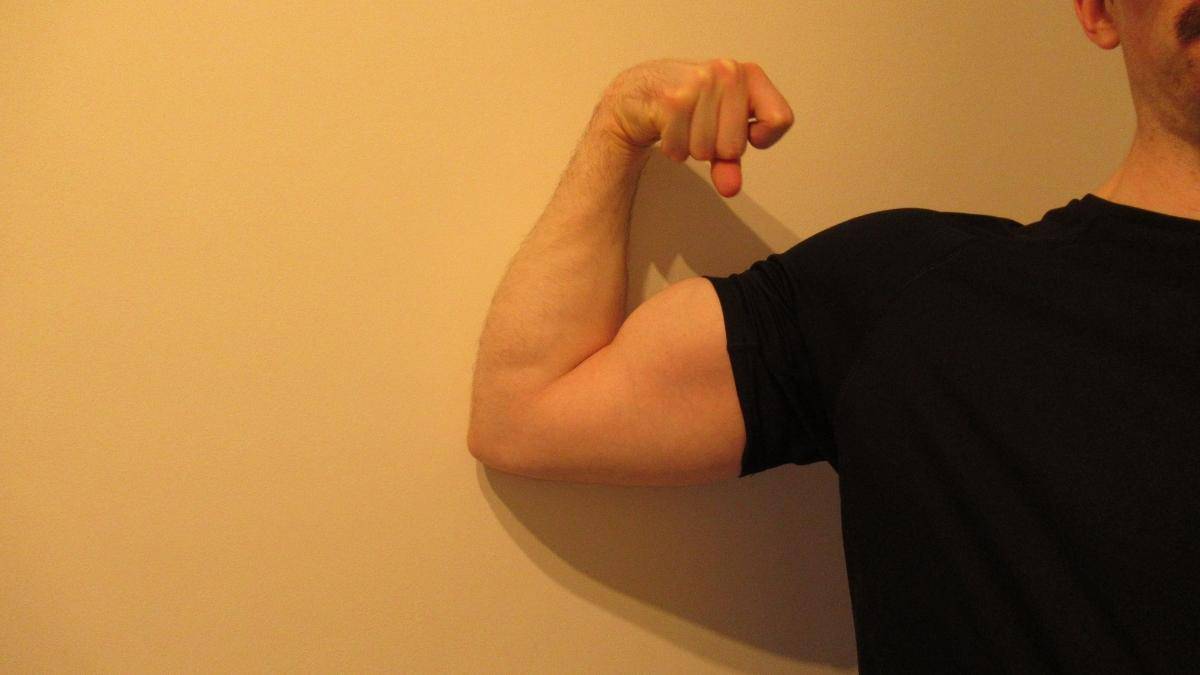 A man showing his 15 inch bicep