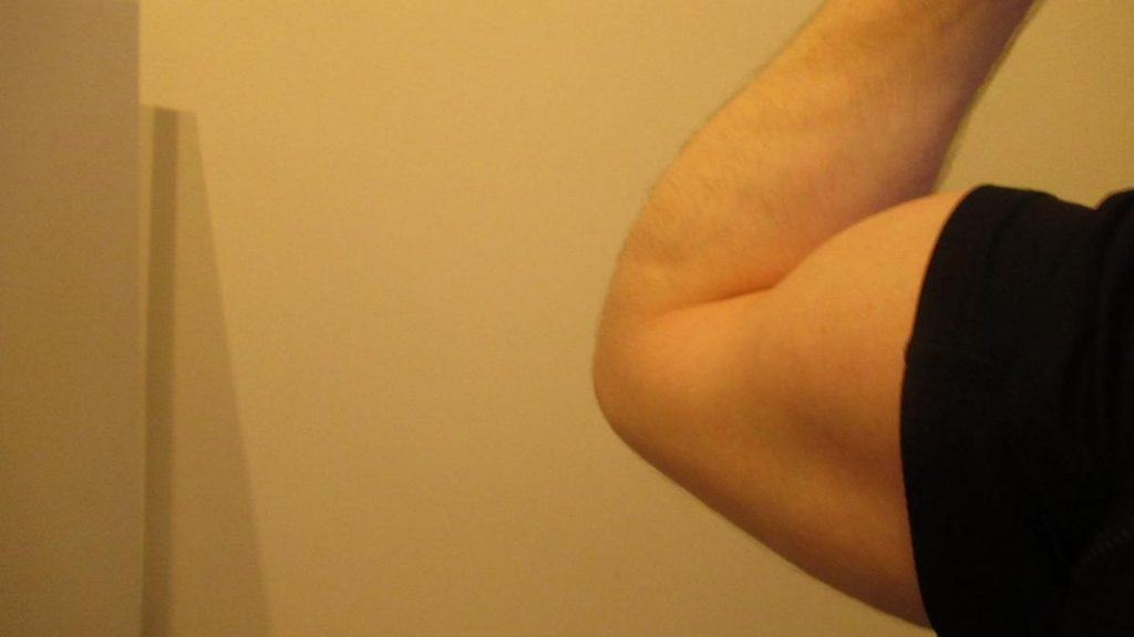 A man with 16 inch biceps flexed