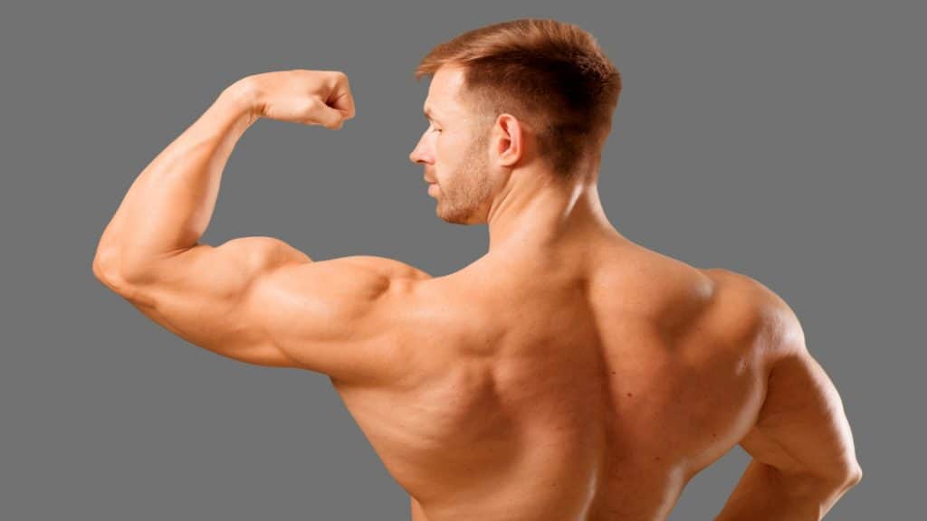 A man flexing his 18 inch biceps