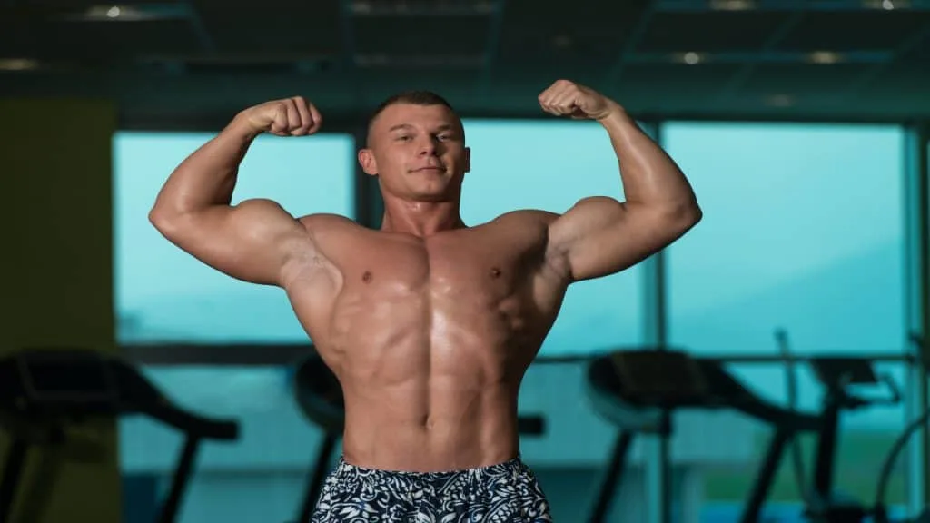 A bodybuilder flexing his 18.5 inch biceps at the gym