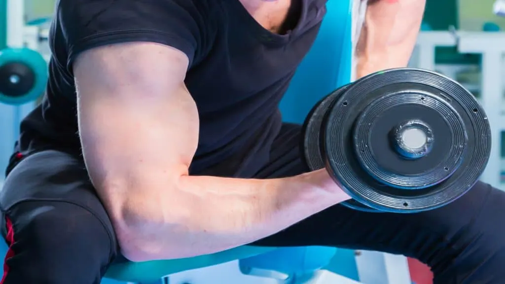 A man doing a 20 pound bicep curl with a dumbbell