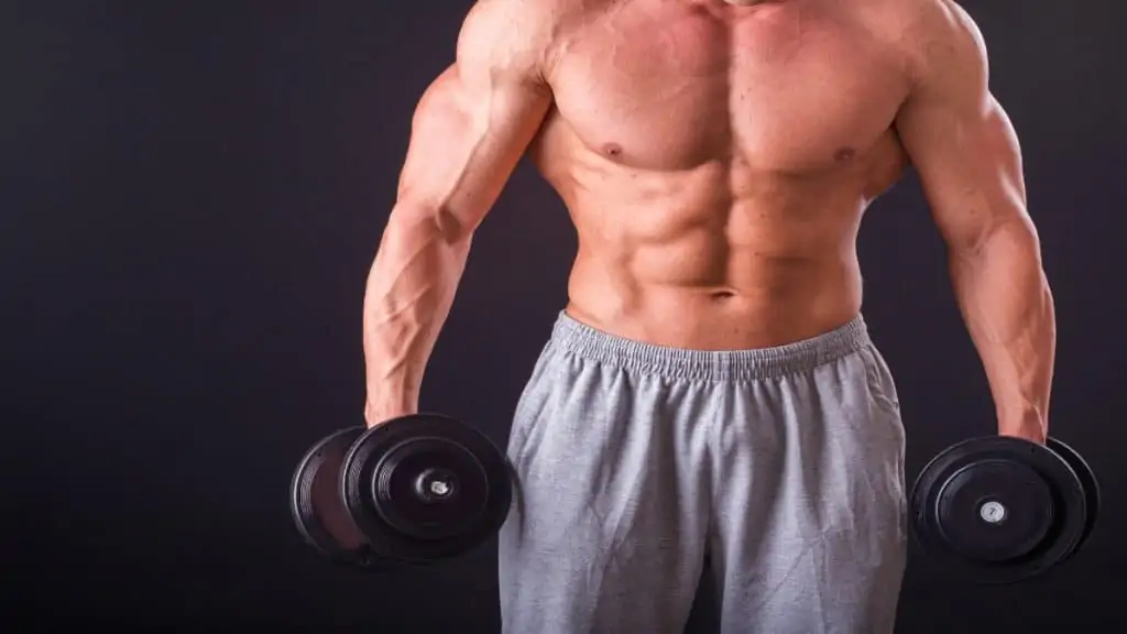 A man with 21 inch arms holding some weights