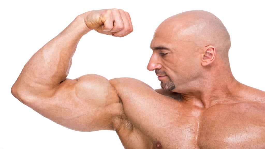 A muscular men showing his 21 inch bicep muscles
