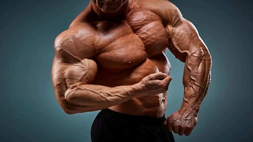 A bodybuilder flexing his 22 inch biceps