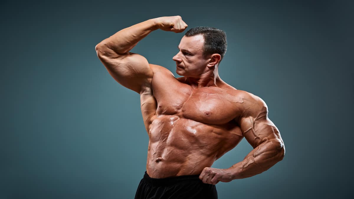 A bodybuilder flexing his 23 inch biceps