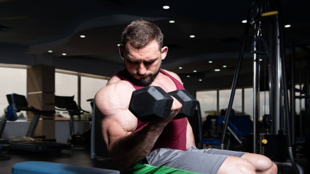 A man doing a 25 lb bicep curl with a dumbbell