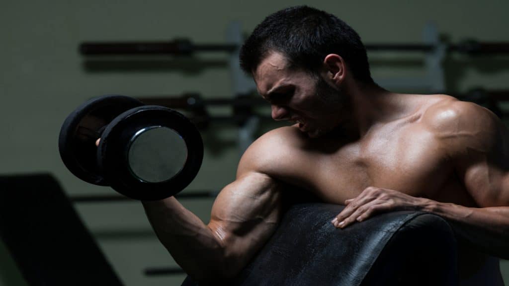 A man performing a 25 pound dumbbell curl for his biceps