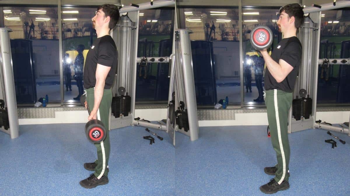 A man doing a 30 kg bicep curl with a barbell