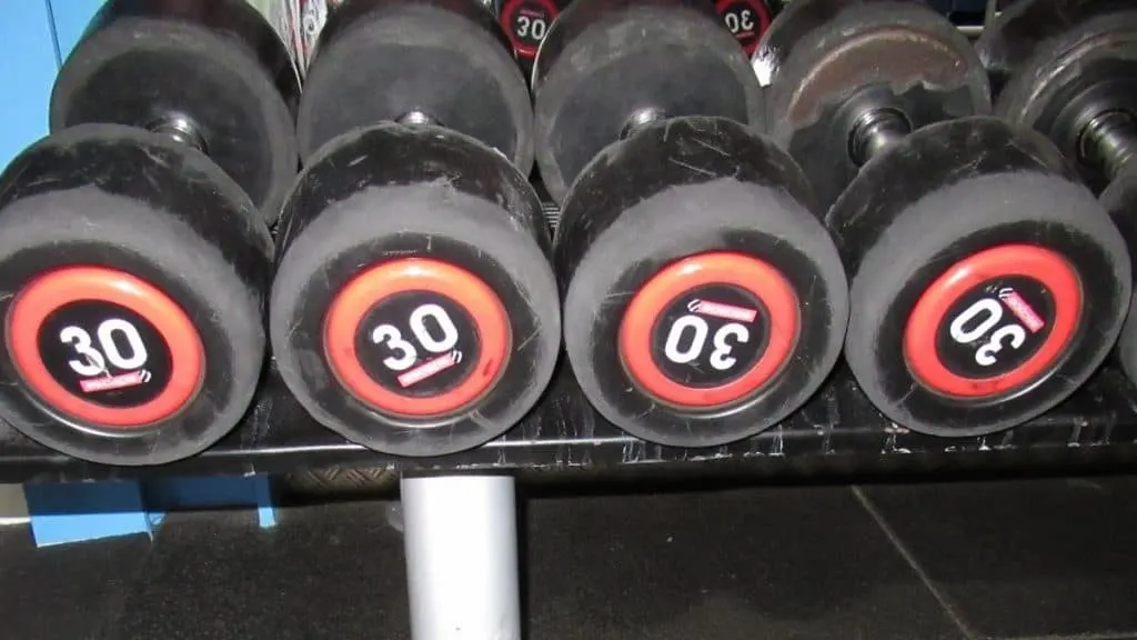 A rack of 30 kg dumbbells used for curls