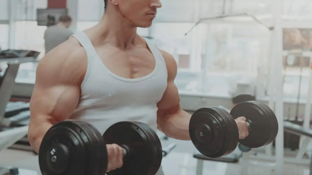 A man performing 50 lb dumbbells curls to work his biceps