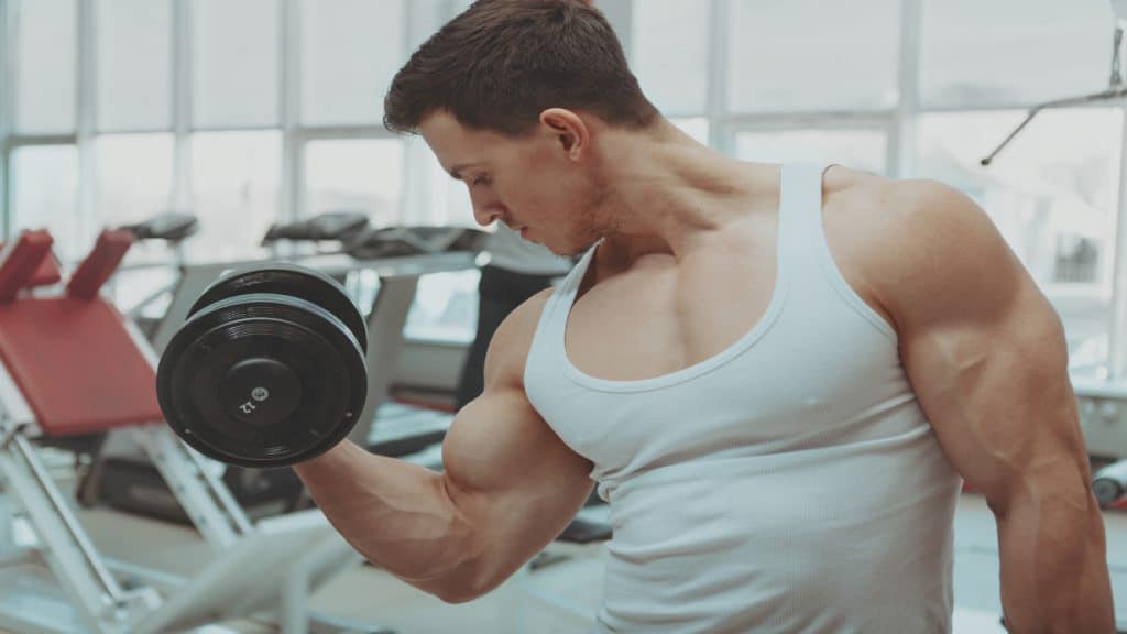 A man performing a 50 pound dumbbell curl for his biceps