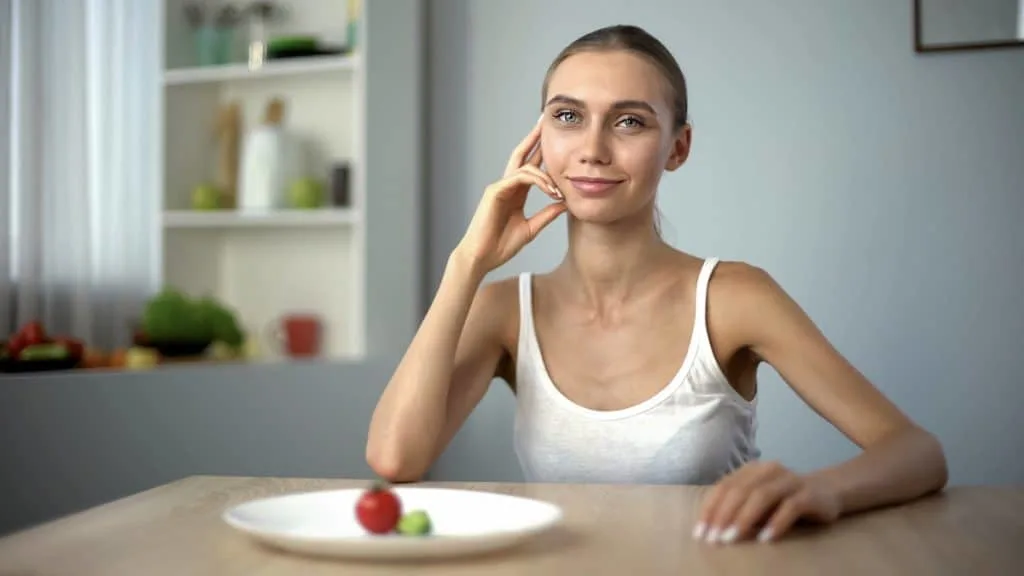 A skinny woman with 7 inch biceps sat at the table