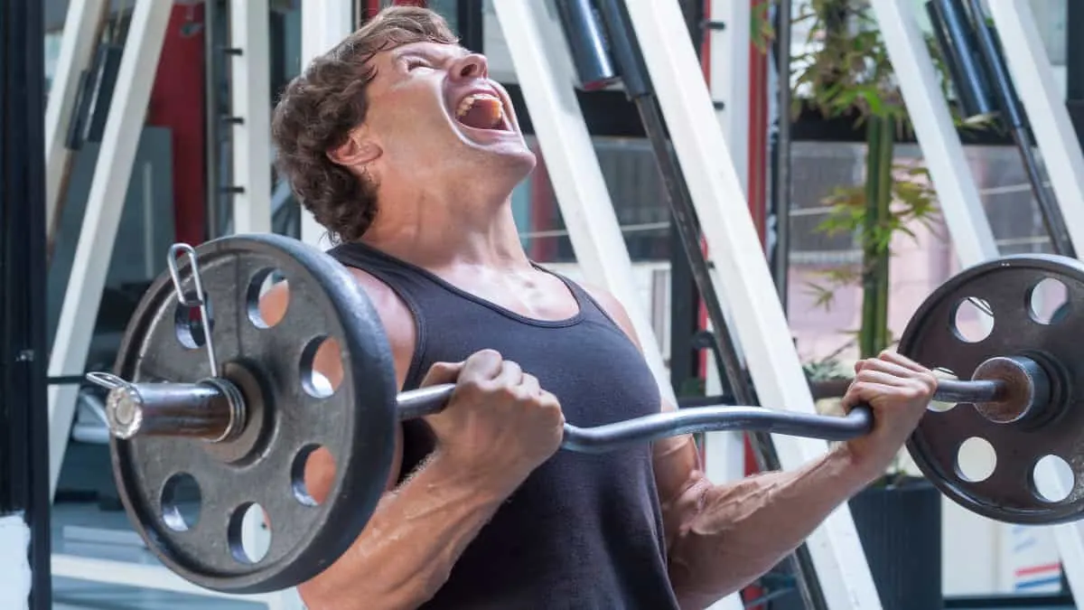 A man performing a 70 kg bicep curl