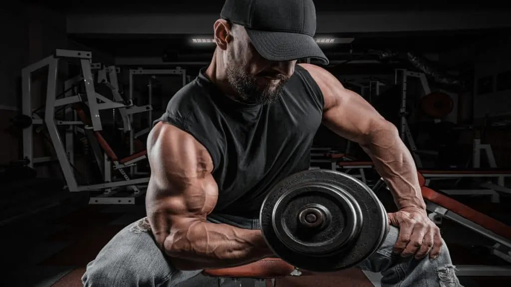 A bodybuilder doing a 70 pound bicep curl with a dumbbell