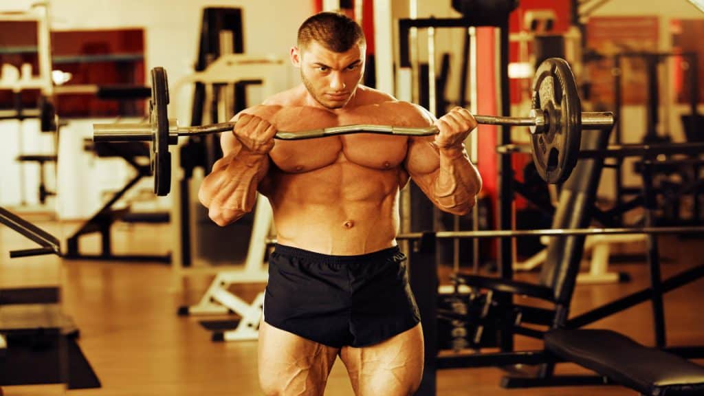 A bodybuilder performing an 80 pound barbell curl for his biceps