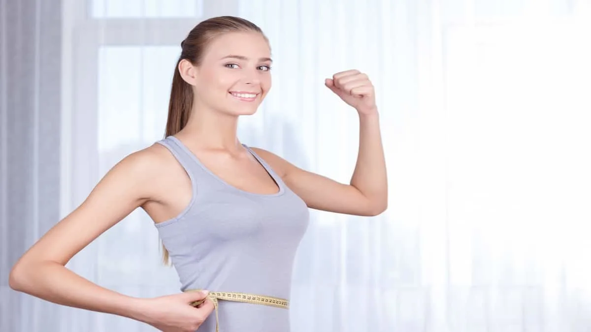 A young woman flexing her 9 inch biceps