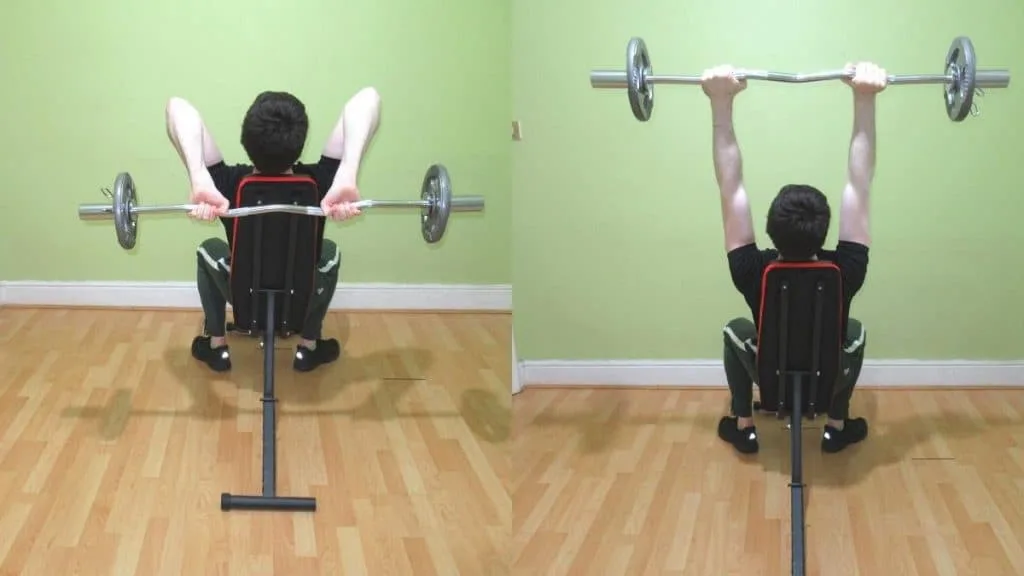 A man doing an EZ seated triceps extension with a cambered bar