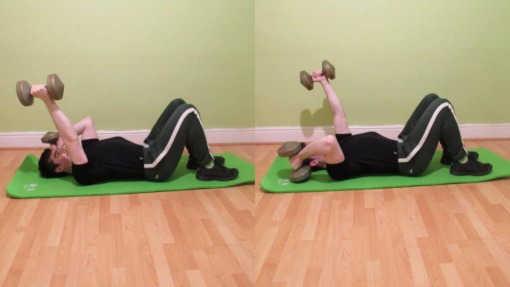 A man doing lying alternating floor tricep extensions with dumbbells