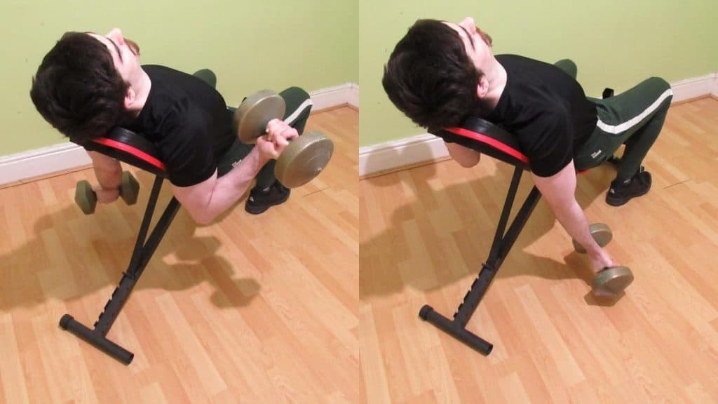 A man performing an alternating incline dumbbell curl