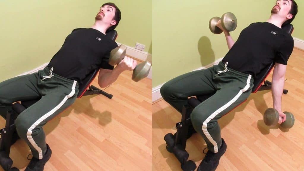 A man doing alternating incline dumbbell curls