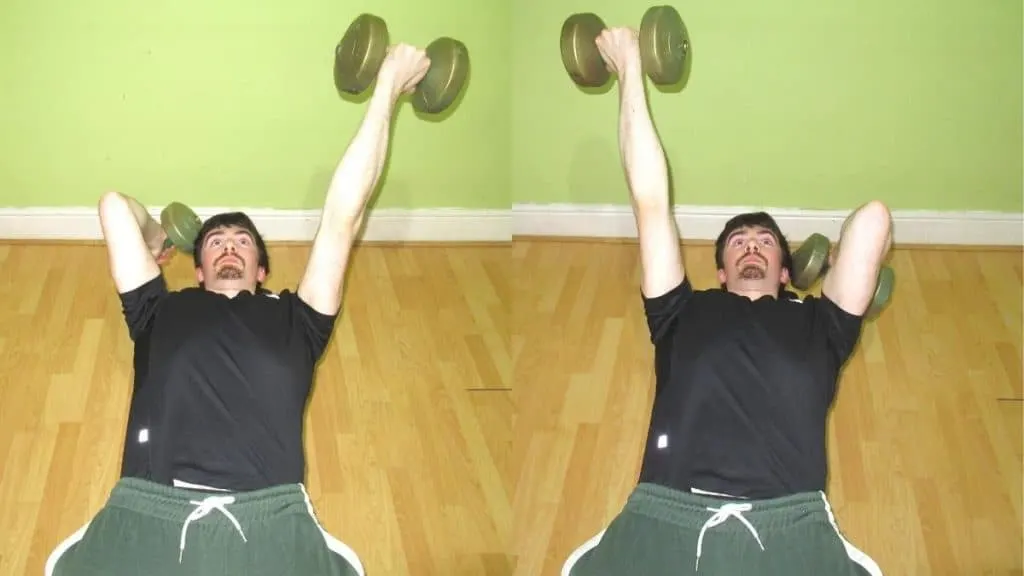 A man doing alternating reverse grip skull crushers