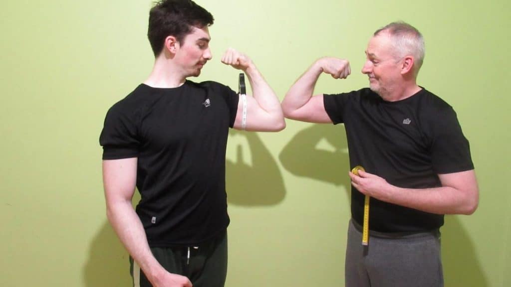 Two men flexing their arms before researching the average bicep size