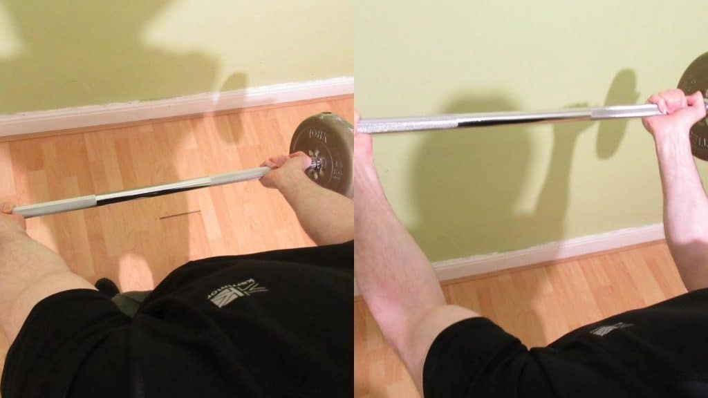 A man performing a barbell curl with a wide grip
