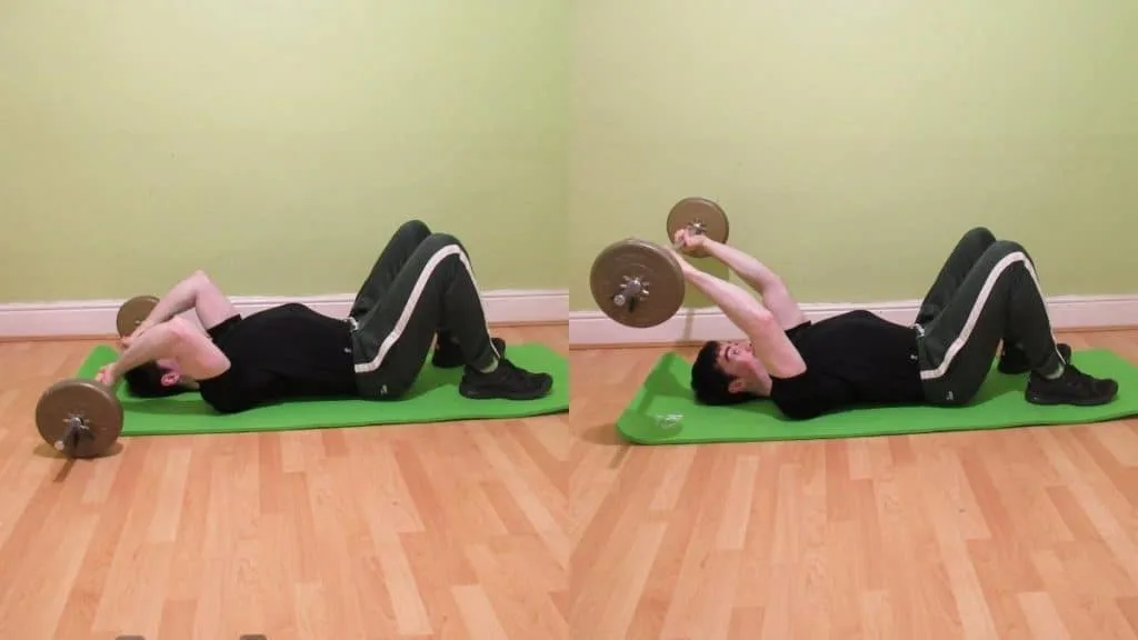 A man performing a barbell floor skull crusher