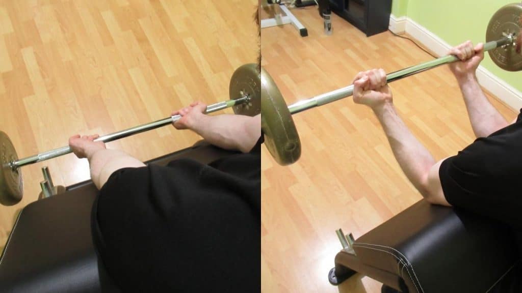 A man doing barbell preacher curls for his biceps