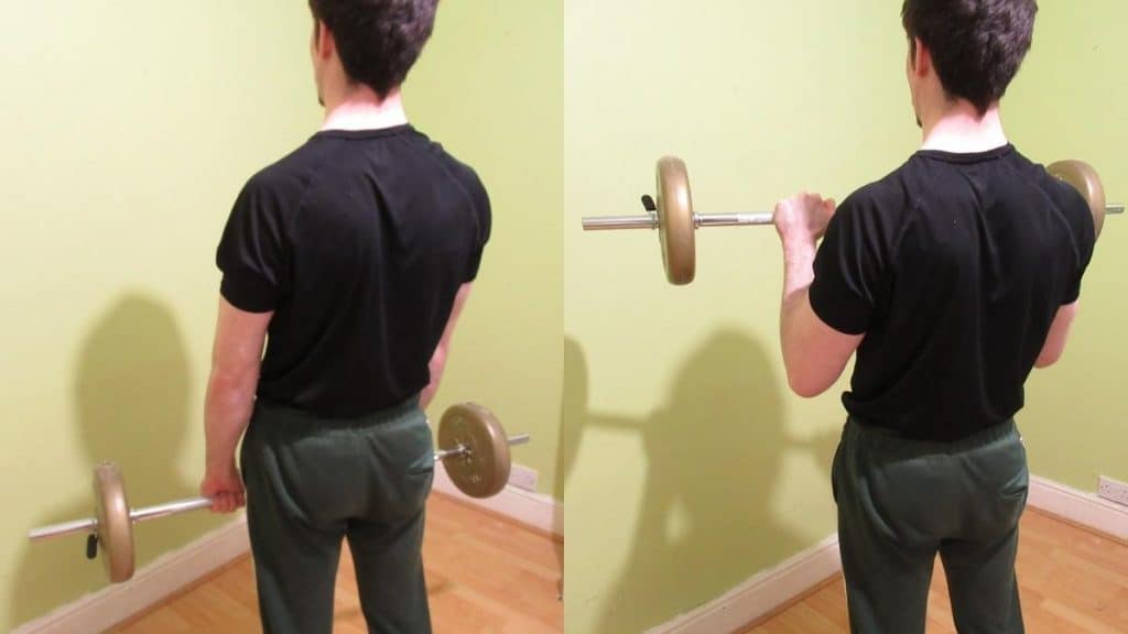 A man performing a barbell pronated curl to work his biceps