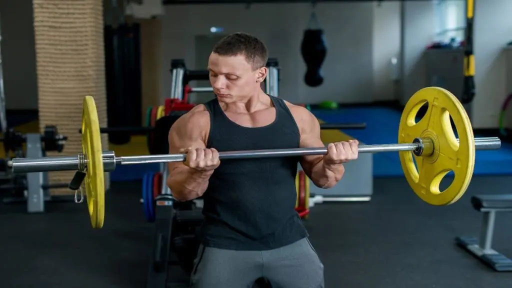 A man doing a bicep curl with 135 pounds