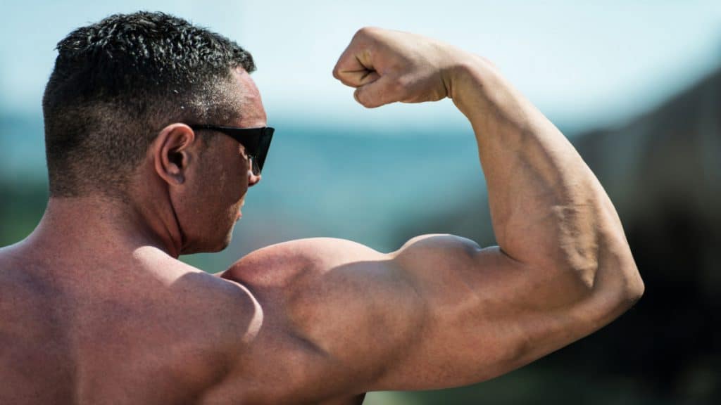 A bodybuilder flexing his muscular biceps