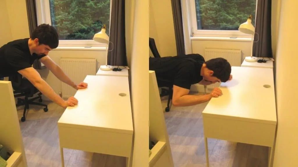 A man doing a bodyweight skull crusher using his desk