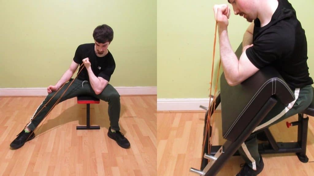A man showing that you can do a concentration curl or preacher curl to work the biceps