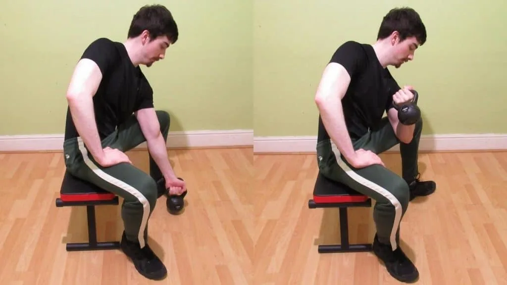 A man doing a concentration kettlebell curl